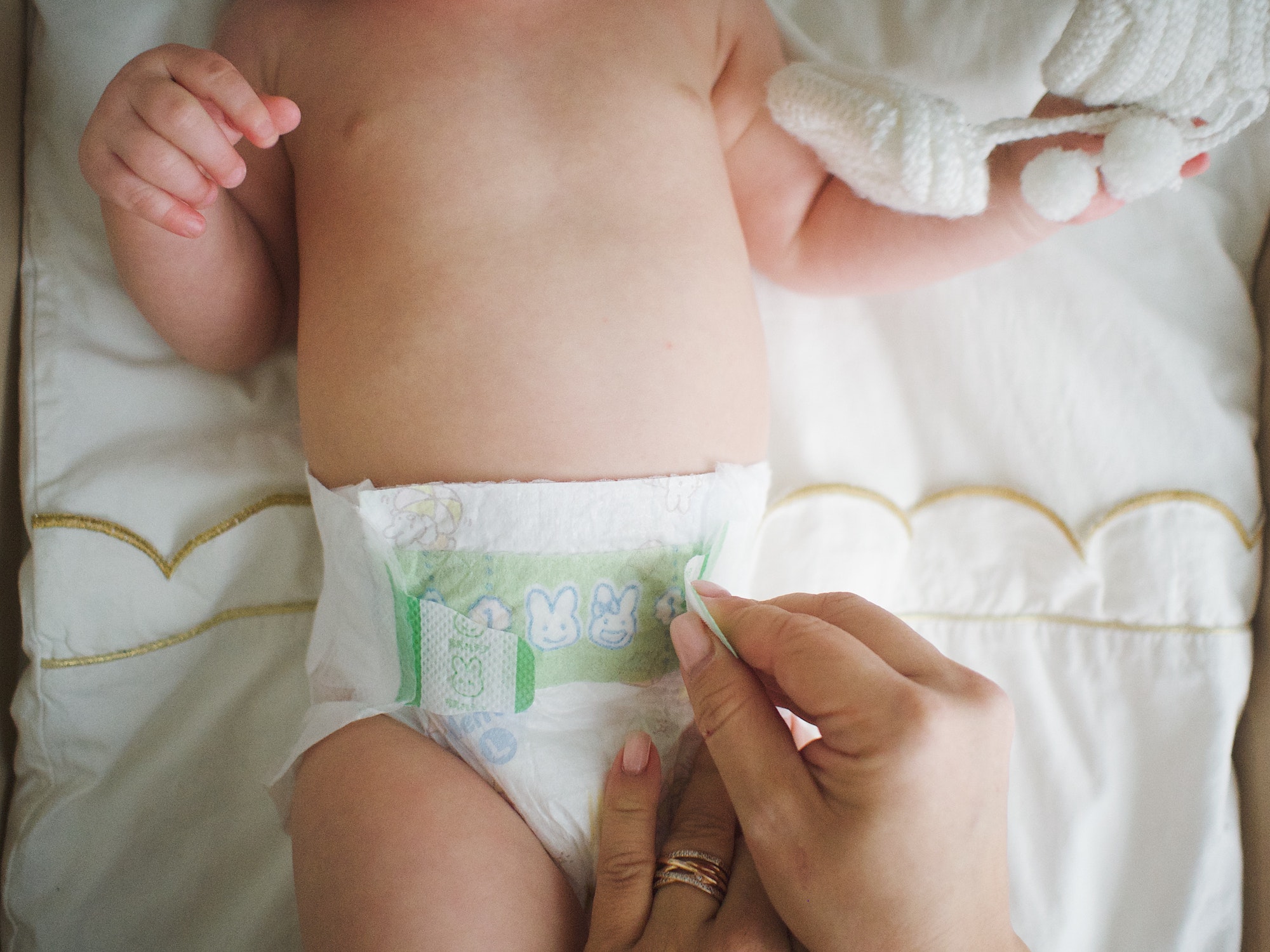 mom changes the baby's diaper
